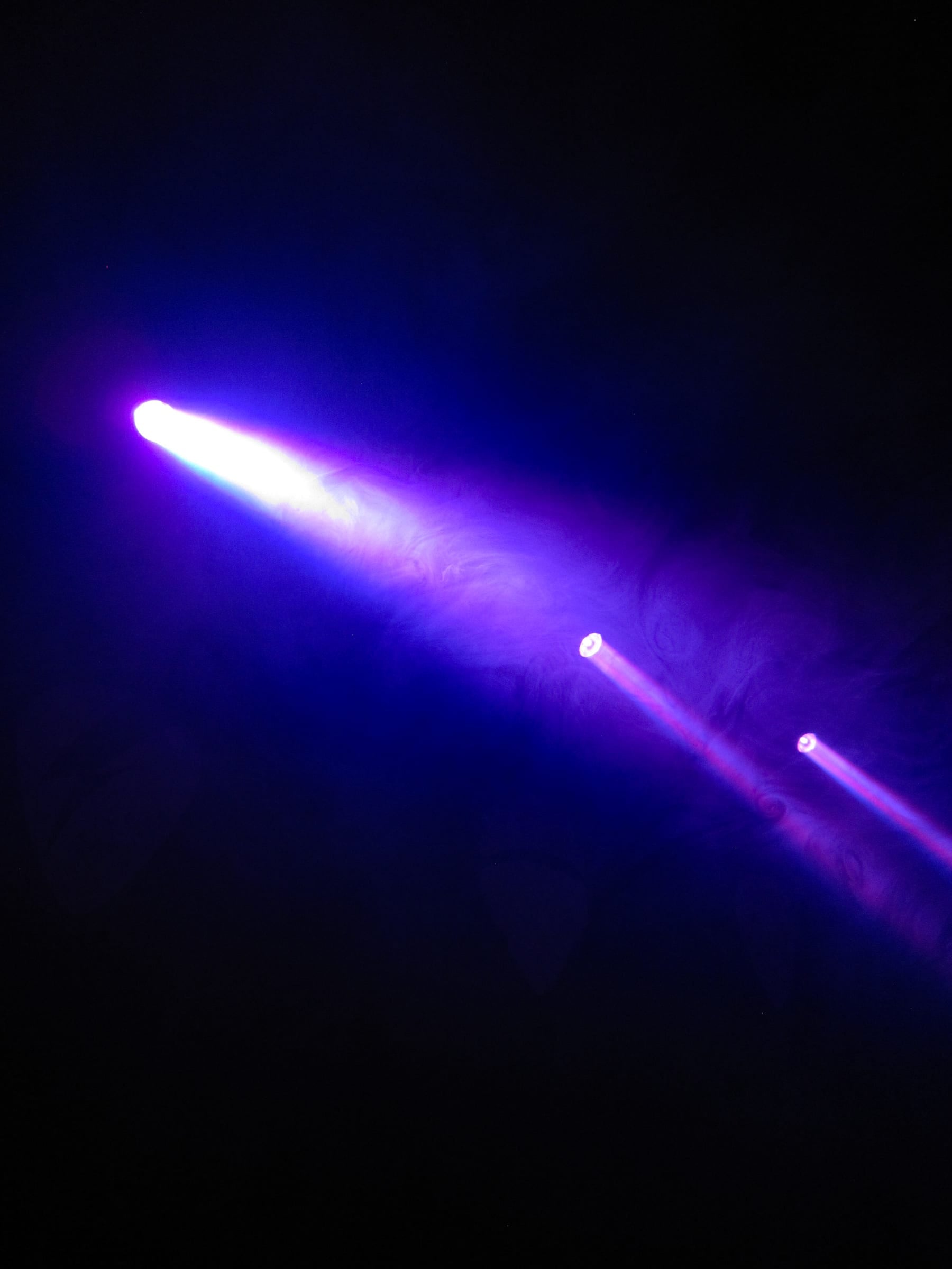 Projecteurs de scène abstraits avec fumée violette dans l'obscurité, photographie argentique couleur